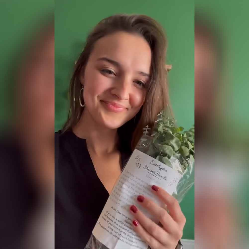 Woman holding Self Care Shower packaging
